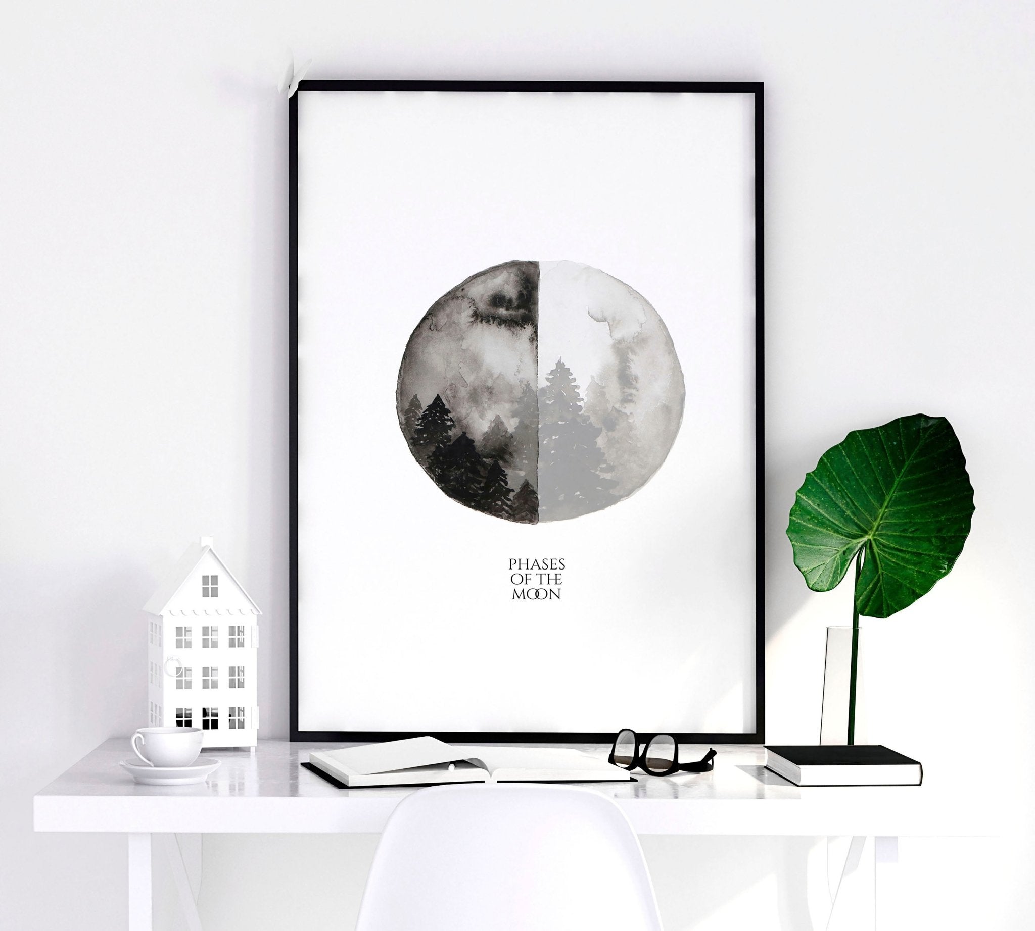 Set of 3 framed wall art prints depicting the phases of the moon in a monochromatic design, perfect for enhancing living room decor.