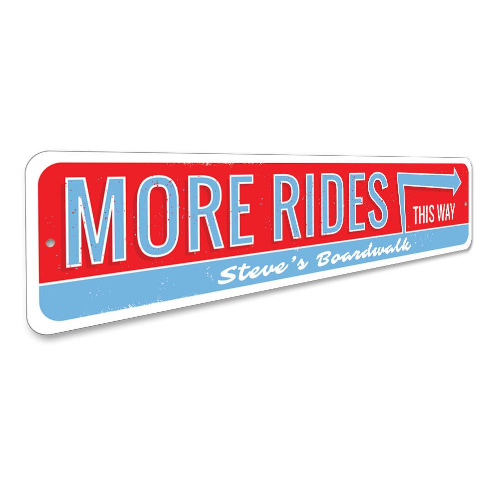 A decorative aluminum sign reading 'More Amusement Rides This Way', featuring vibrant colors and a coastal theme, perfect for beach houses.