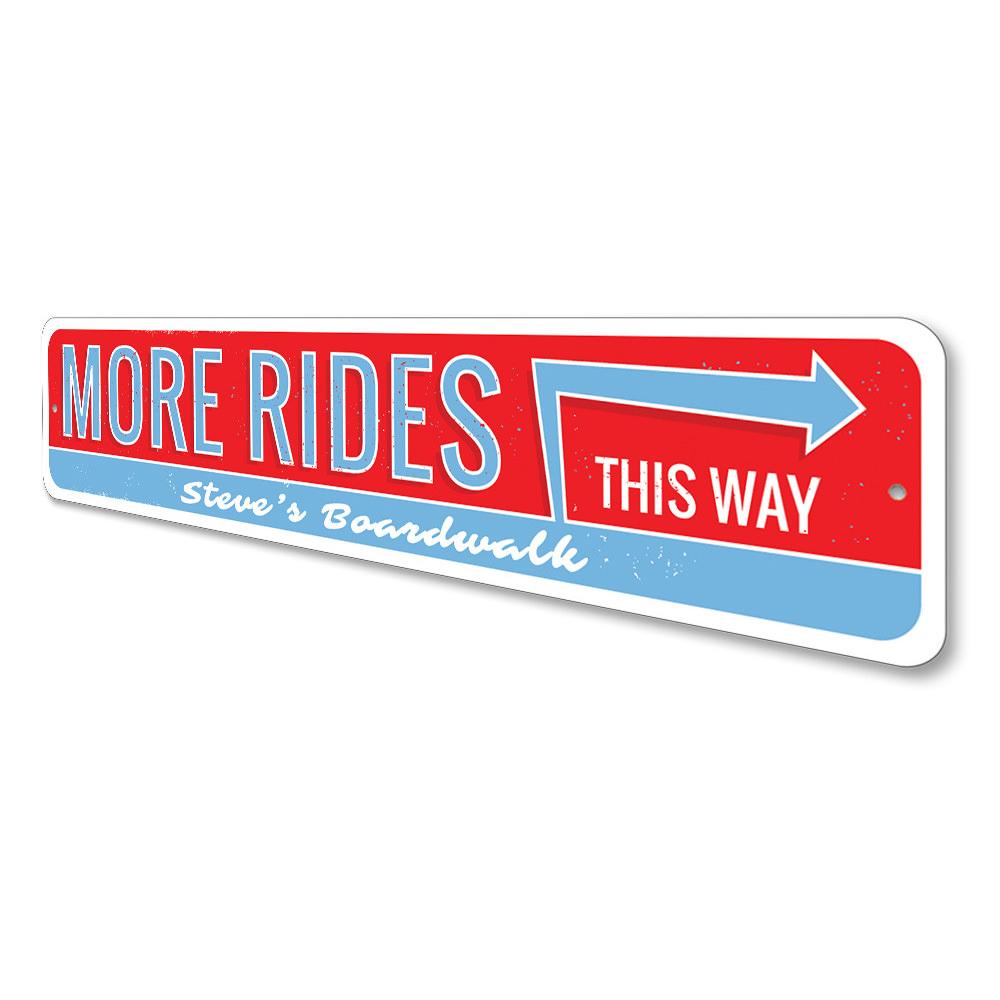 A decorative aluminum sign reading 'More Amusement Rides This Way', featuring vibrant colors and a coastal theme, perfect for beach houses.