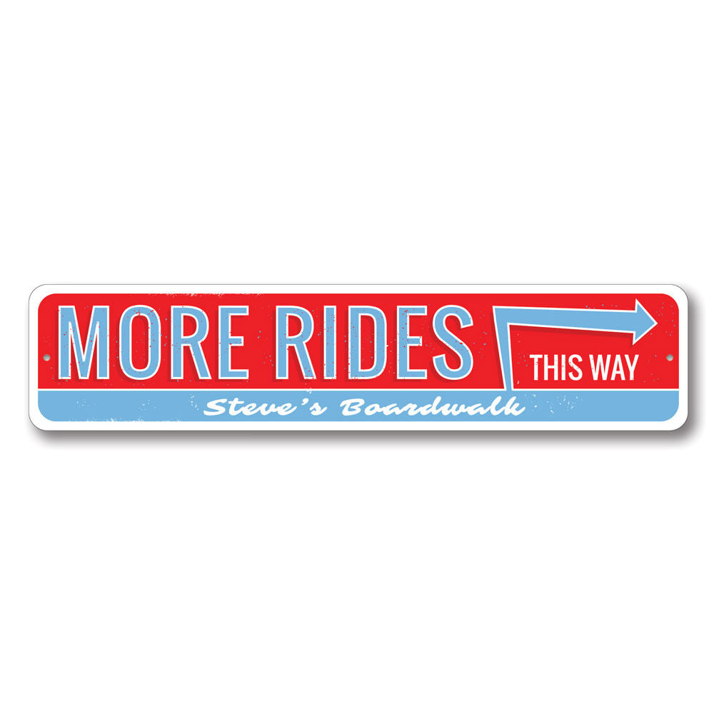 A decorative aluminum sign reading 'More Amusement Rides This Way', featuring vibrant colors and a coastal theme, perfect for beach houses.