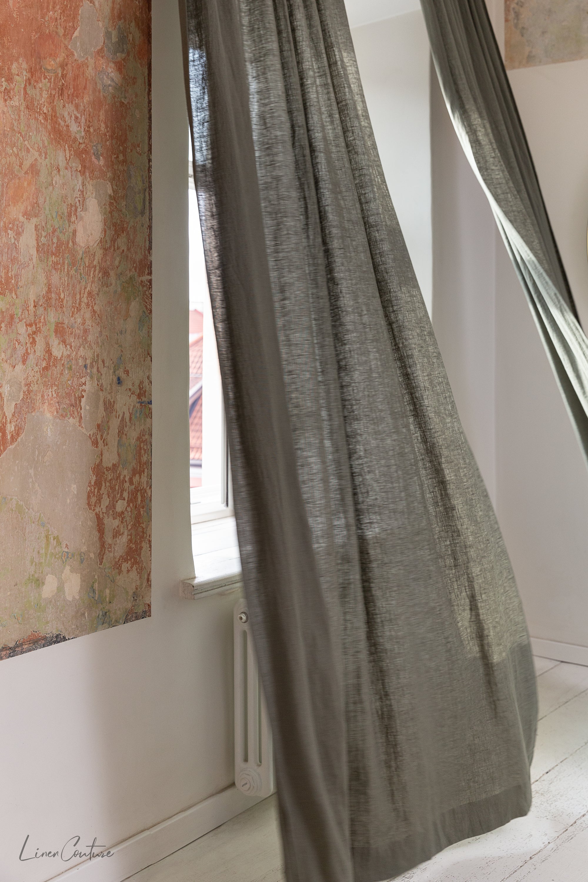 Moss green linen curtain with rod pocket, showcasing its semi-sheer texture and elegant color.