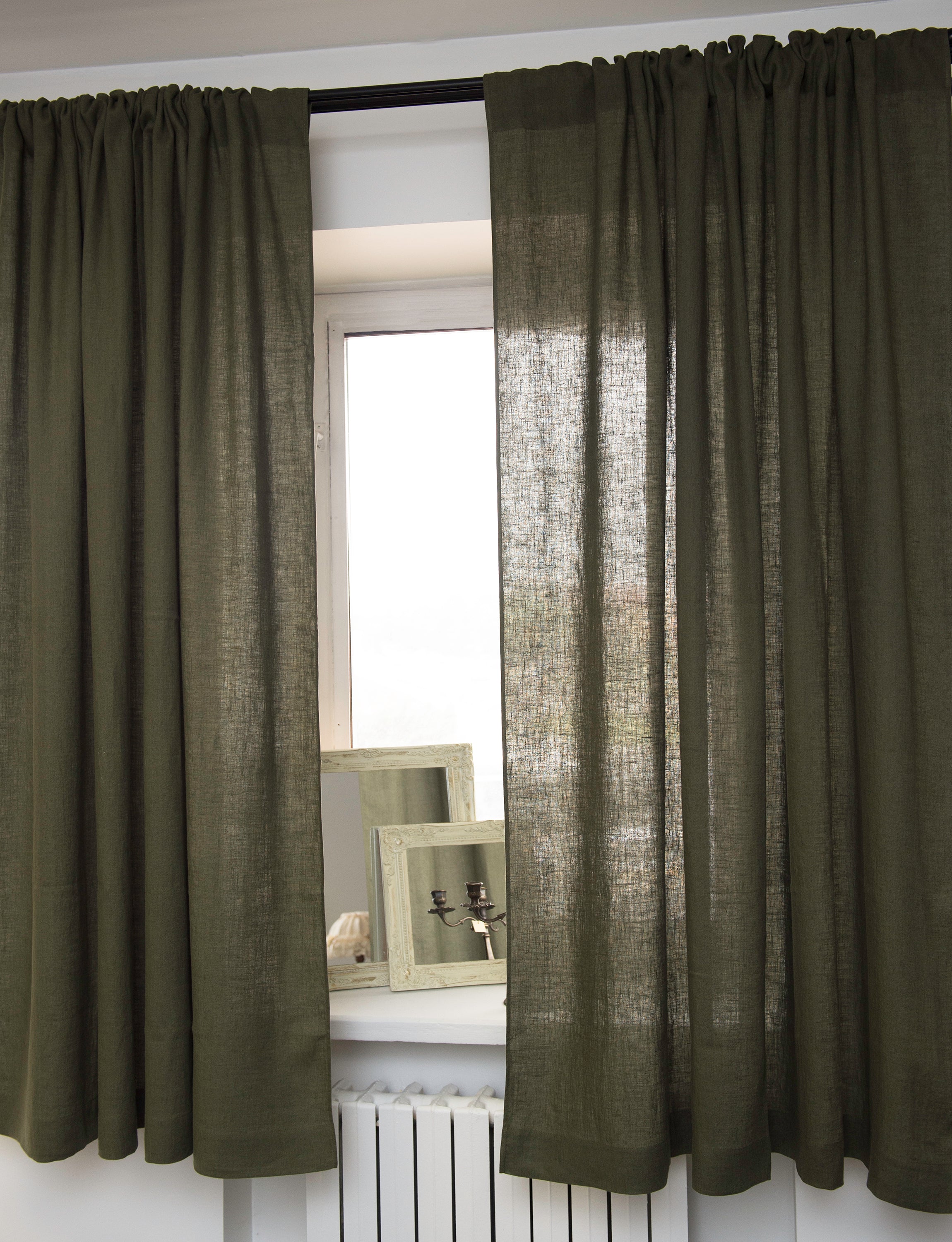 Moss green linen curtain with rod pocket, showcasing its semi-sheer texture and elegant color.