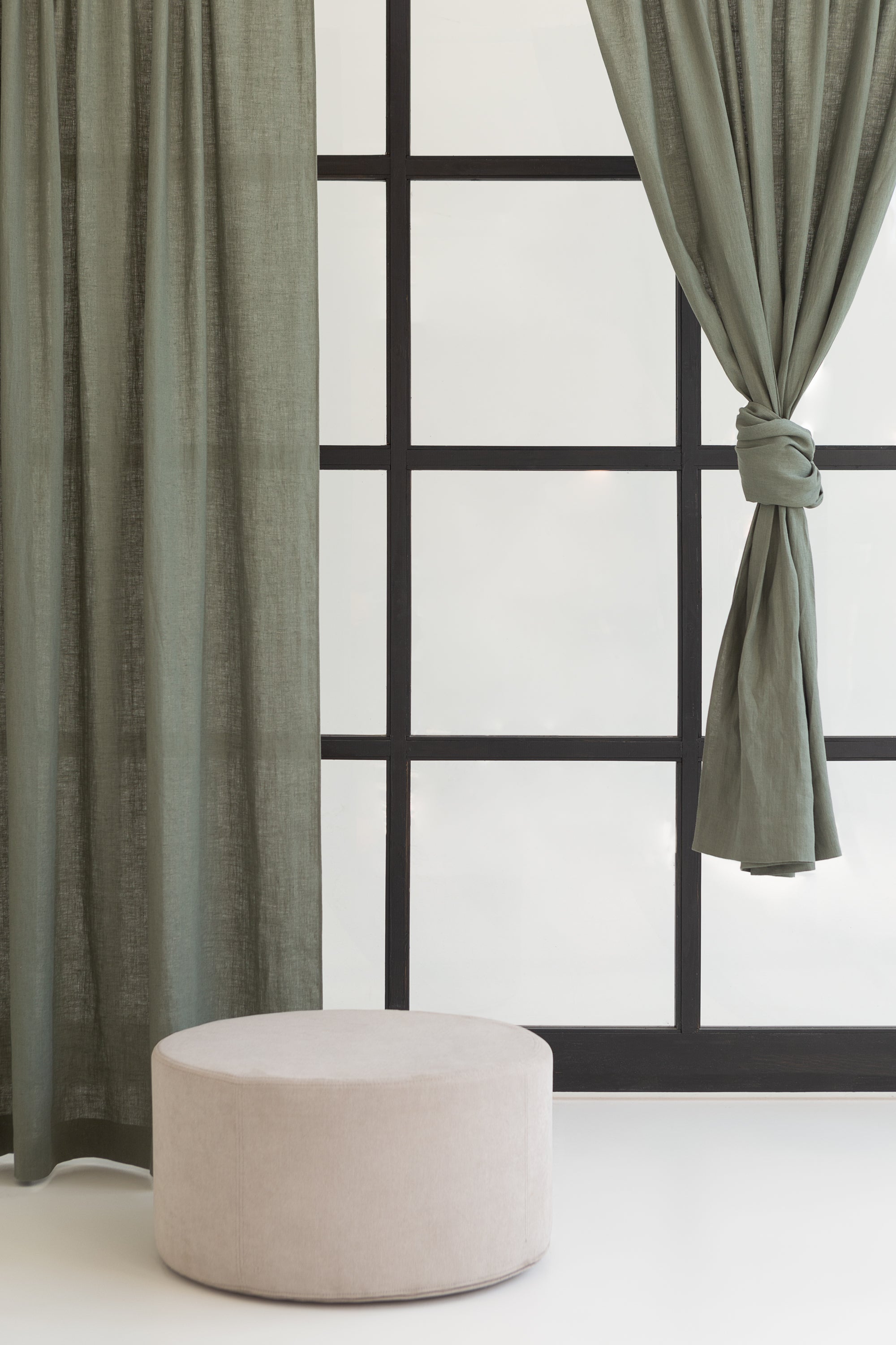 Moss green linen curtain with rod pocket, showcasing its semi-sheer texture and elegant color.