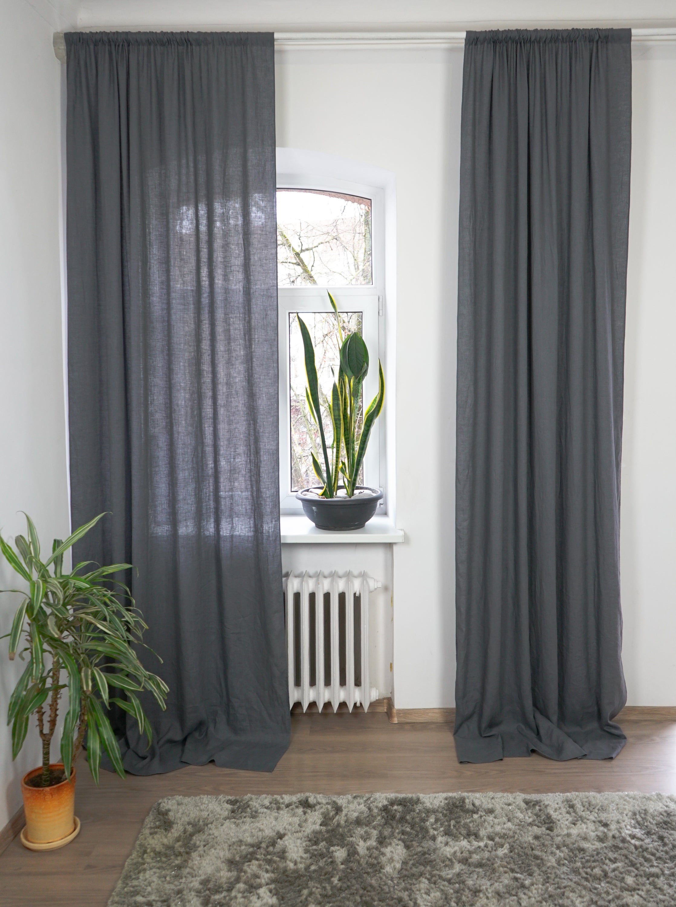 Moss green linen curtain with rod pocket, showcasing its semi-sheer texture and elegant color.