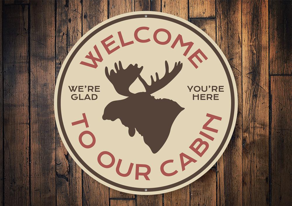 Moose Cabin Welcome Sign made of high-quality aluminum, featuring a rustic design perfect for lakehouse decor.