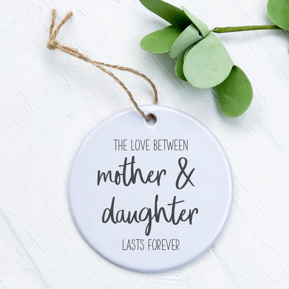 A beautifully crafted porcelain ornament featuring a heartfelt Mother Daughter Love design, perfect for gifting.