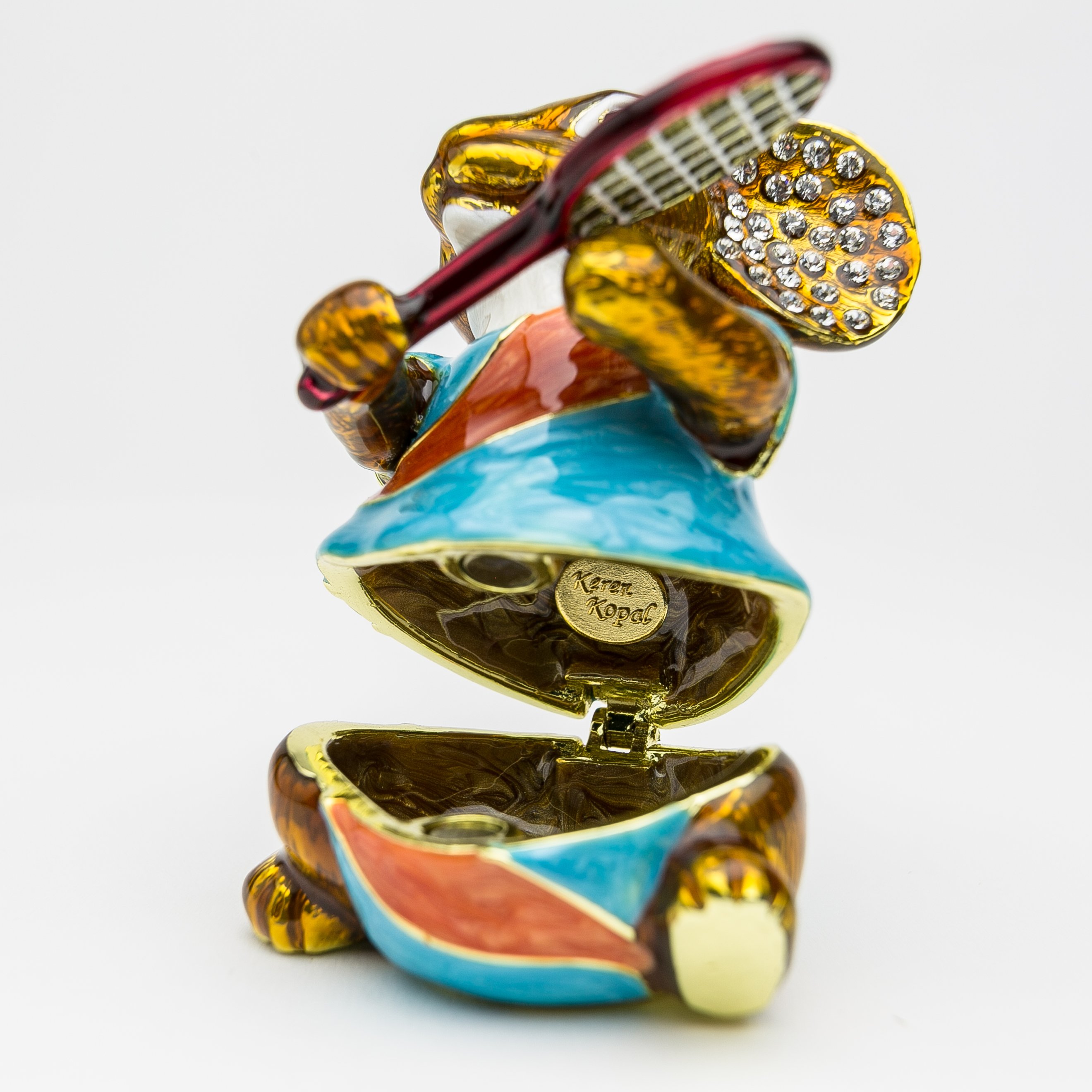 A beautifully crafted enamel trinket box featuring a mouse playing tennis, adorned with Austrian crystals and plated with 24K gold.