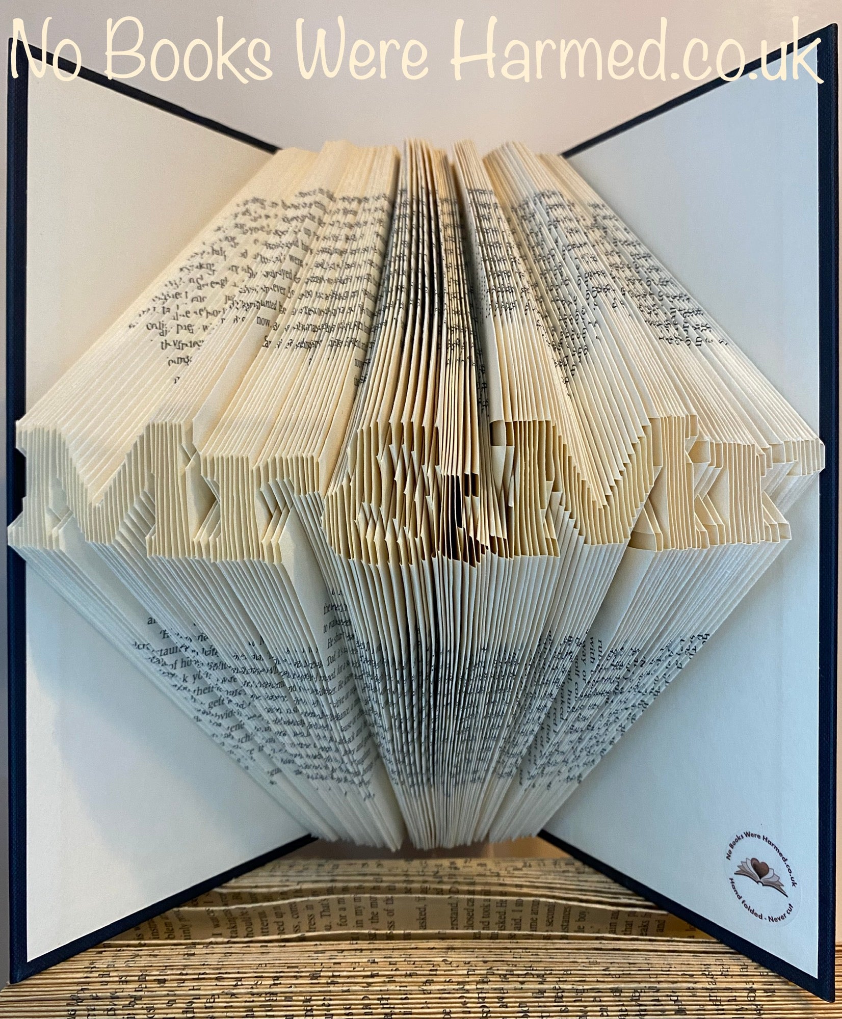 Handcrafted Mr&Mr book art made from vintage books, showcasing intricate folded pages in unique designs.