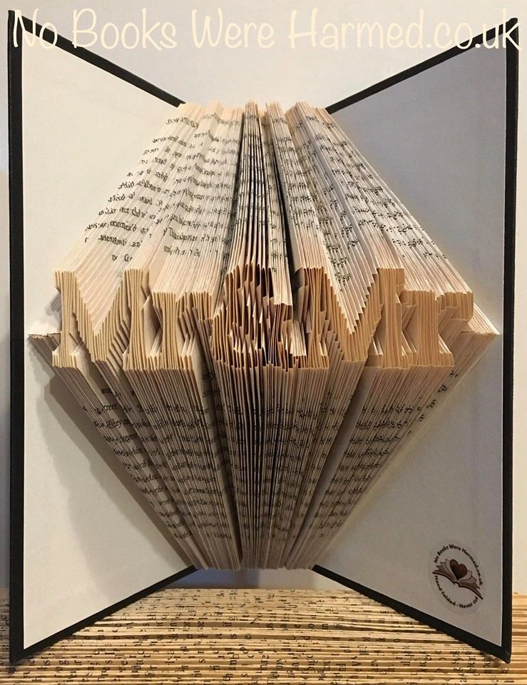 Handcrafted Mr&Mr book art made from vintage books, showcasing intricate folded pages in unique designs.