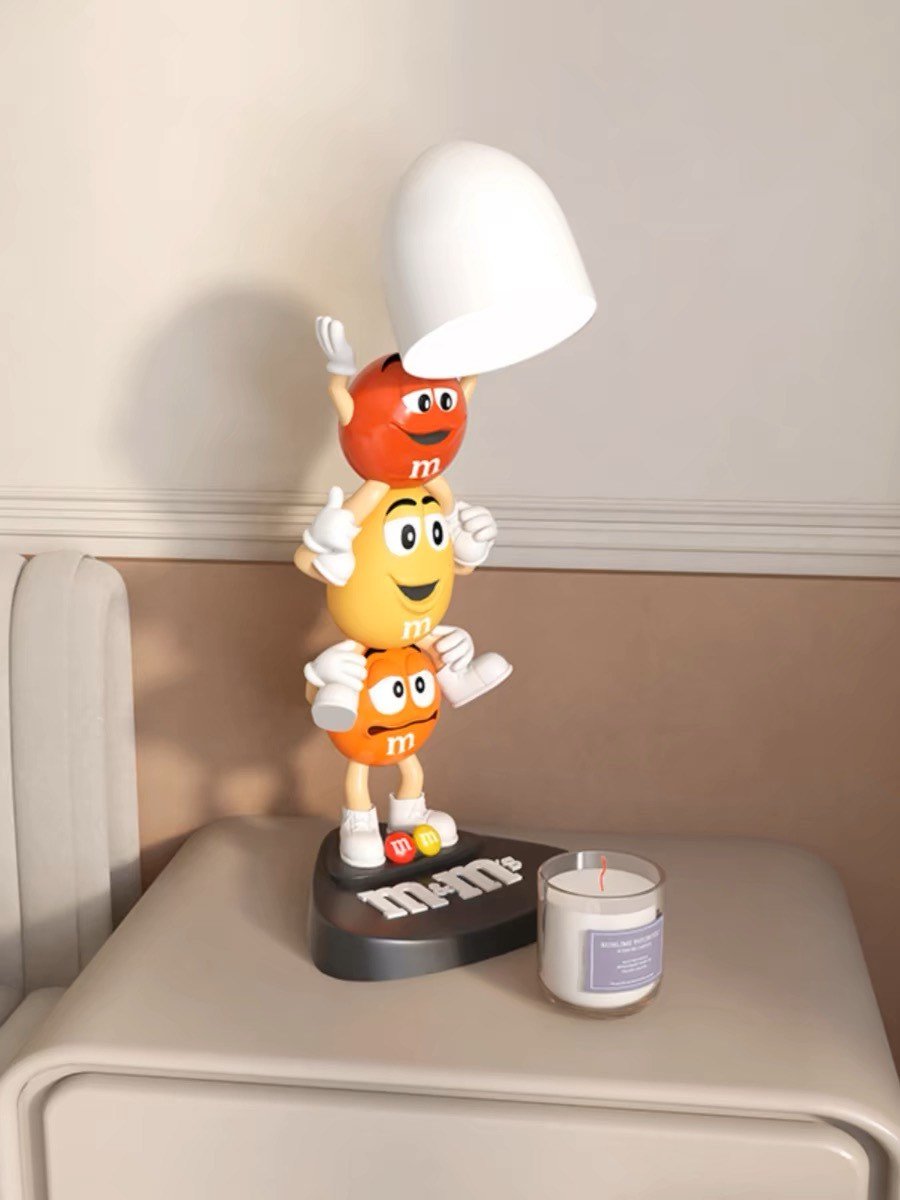 M&M's Cute Candle Warmer Lamp featuring playful cartoon figures, designed for large candles, providing light and fragrance safely.