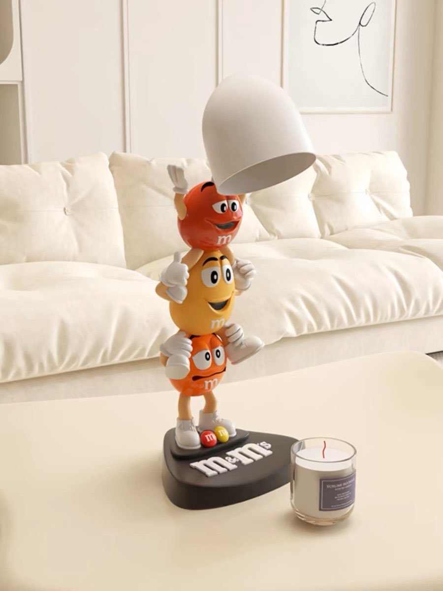 M&M's Cute Candle Warmer Lamp featuring playful cartoon figures, designed for large candles, providing light and fragrance safely.