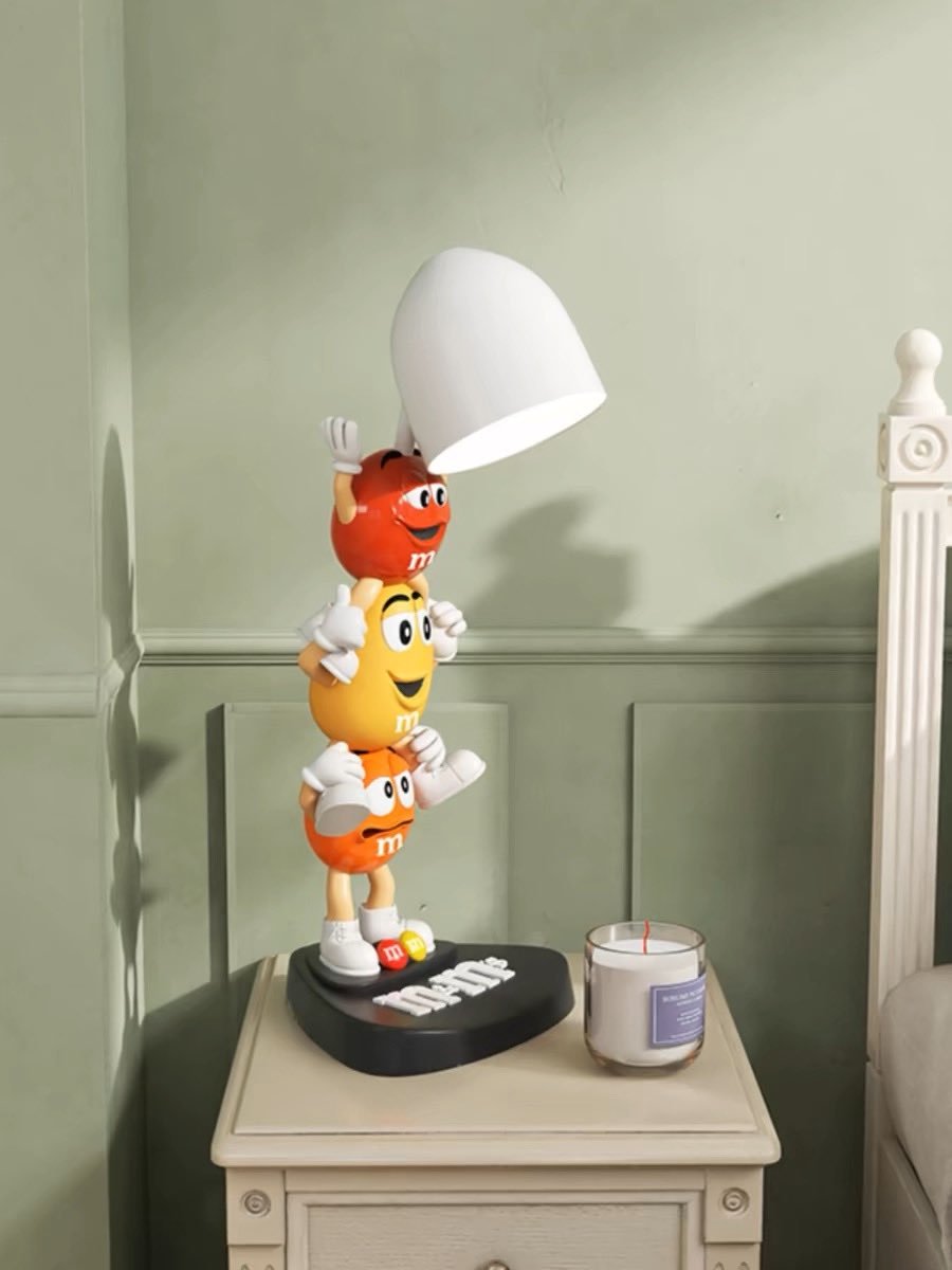 M&M's Cute Candle Warmer Lamp featuring playful cartoon figures, designed for large candles, providing light and fragrance safely.