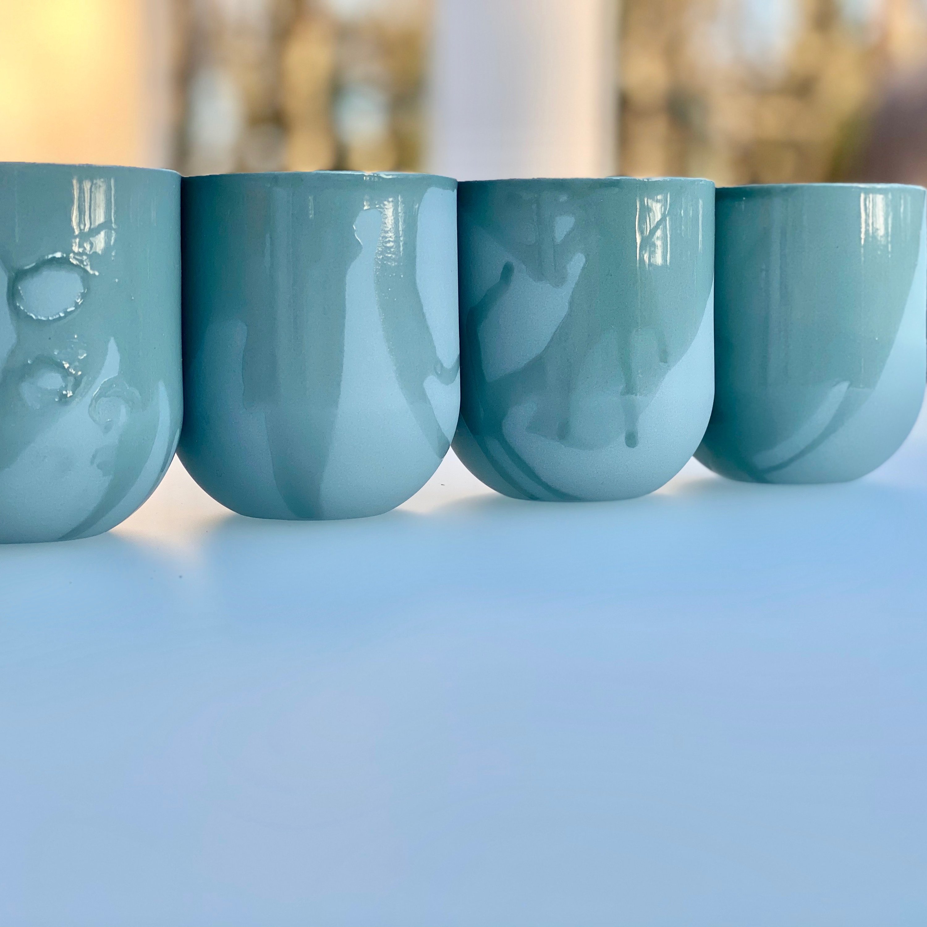 Set of 4 SUM MONO RAW MUGS in muted blue-green with a raw matte finish, showcasing their unique handcrafted design.