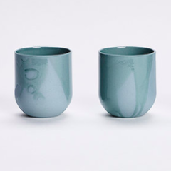 Set of 4 SUM MONO RAW MUGS in muted blue-green with a raw matte finish, showcasing their unique handcrafted design.