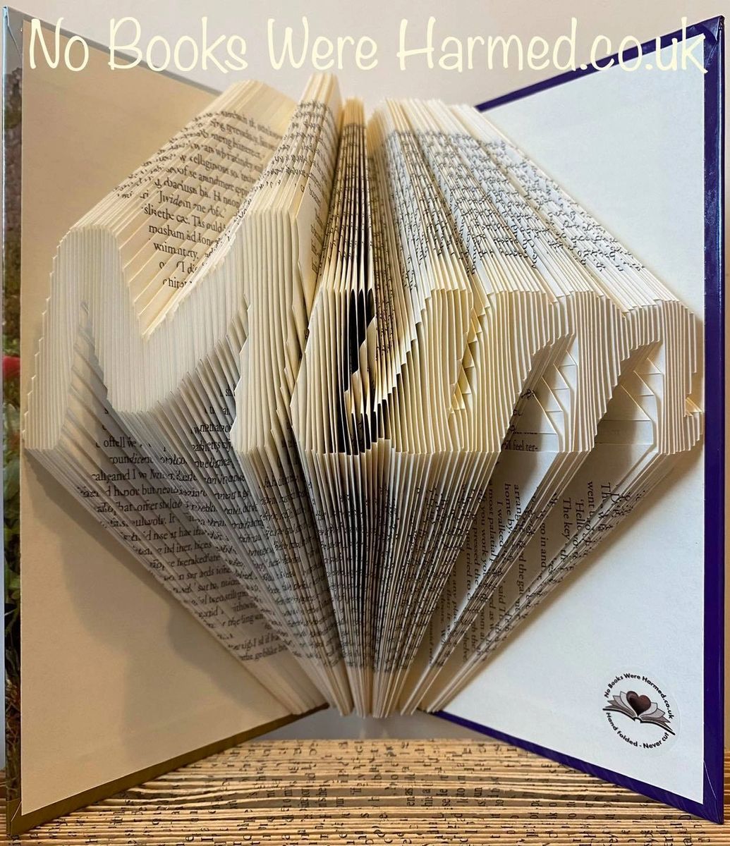 A beautifully crafted Mum art piece made from vintage book pages, showcasing intricate hand-folded designs.