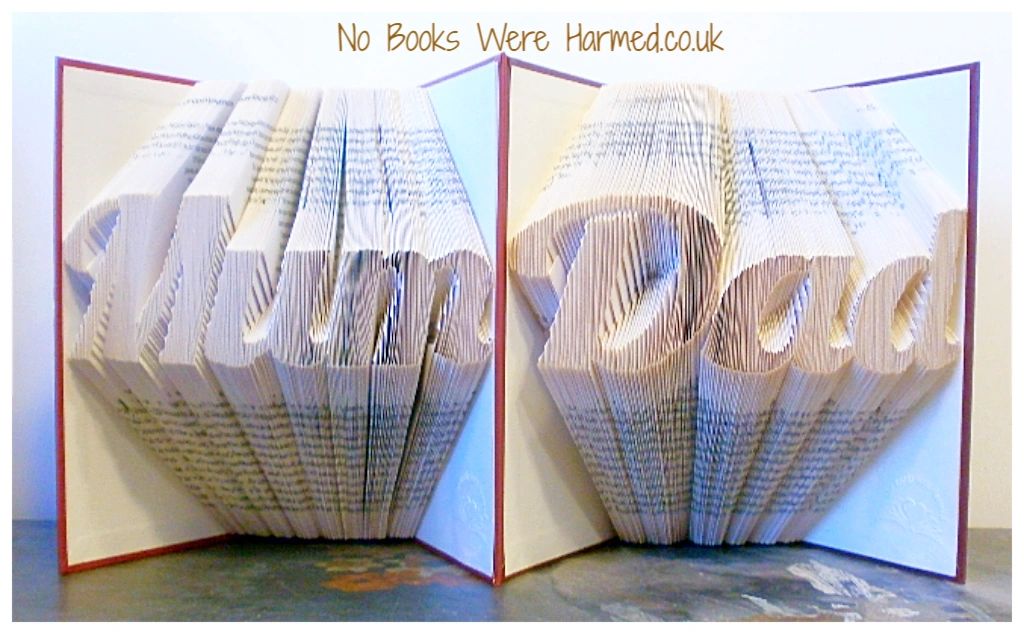 Hand-folded book art featuring the words 'Mum' and 'Dad' from vintage books, showcasing unique designs and craftsmanship.