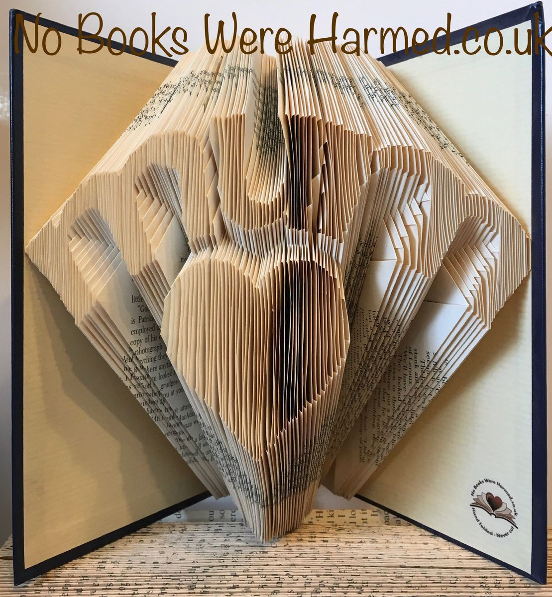 Handcrafted 'Mum' over love heart art made from vintage book pages, showcasing intricate folds and unique design.