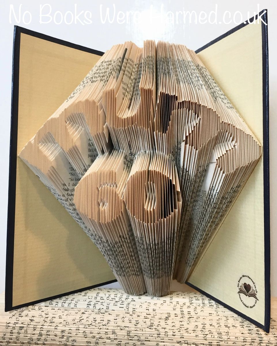 Hand-folded book art featuring 'Mum' over number design, showcasing unique folds from vintage books.