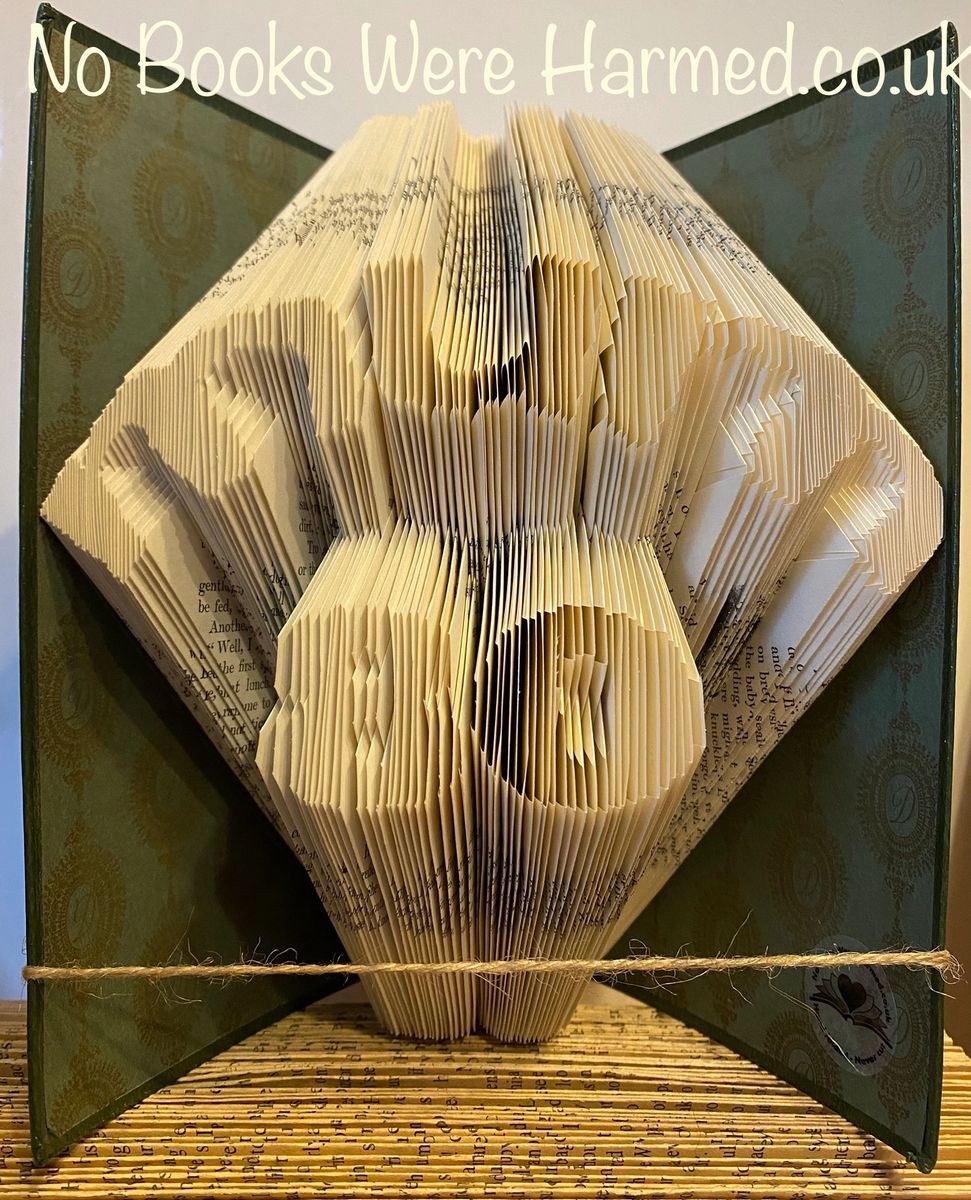 Hand-folded book art featuring 'Mum' over number design, showcasing unique folds from vintage books.