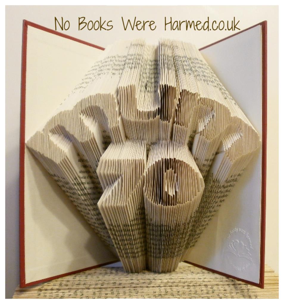 Hand-folded book art featuring 'Mum' over number design, showcasing unique folds from vintage books.