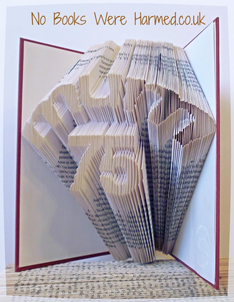 Hand-folded book art featuring 'Mum' over number design, showcasing unique folds from vintage books.