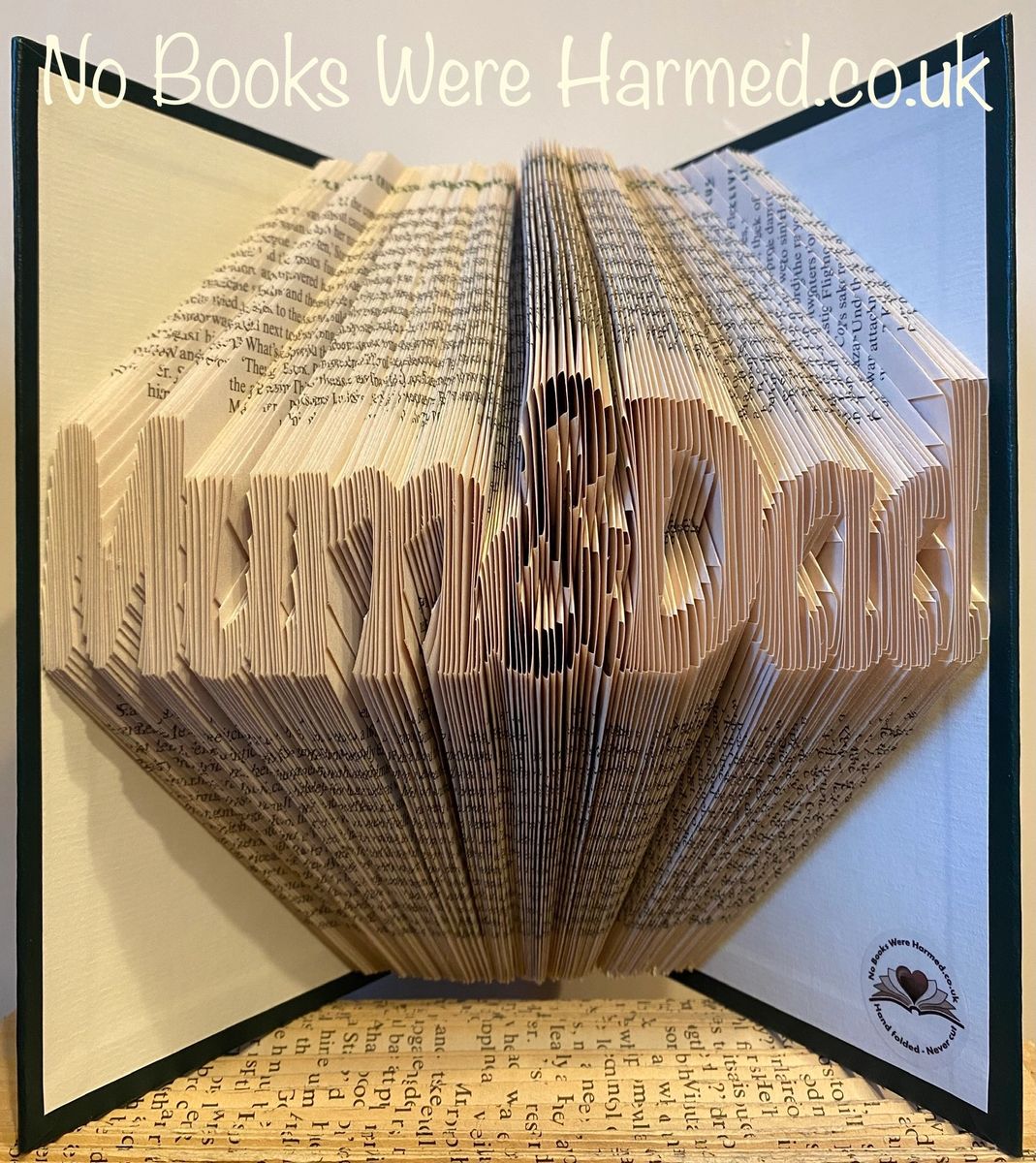 Handcrafted Mum&Dad book art featuring intricately folded pages from vintage books, showcasing unique designs and colors.