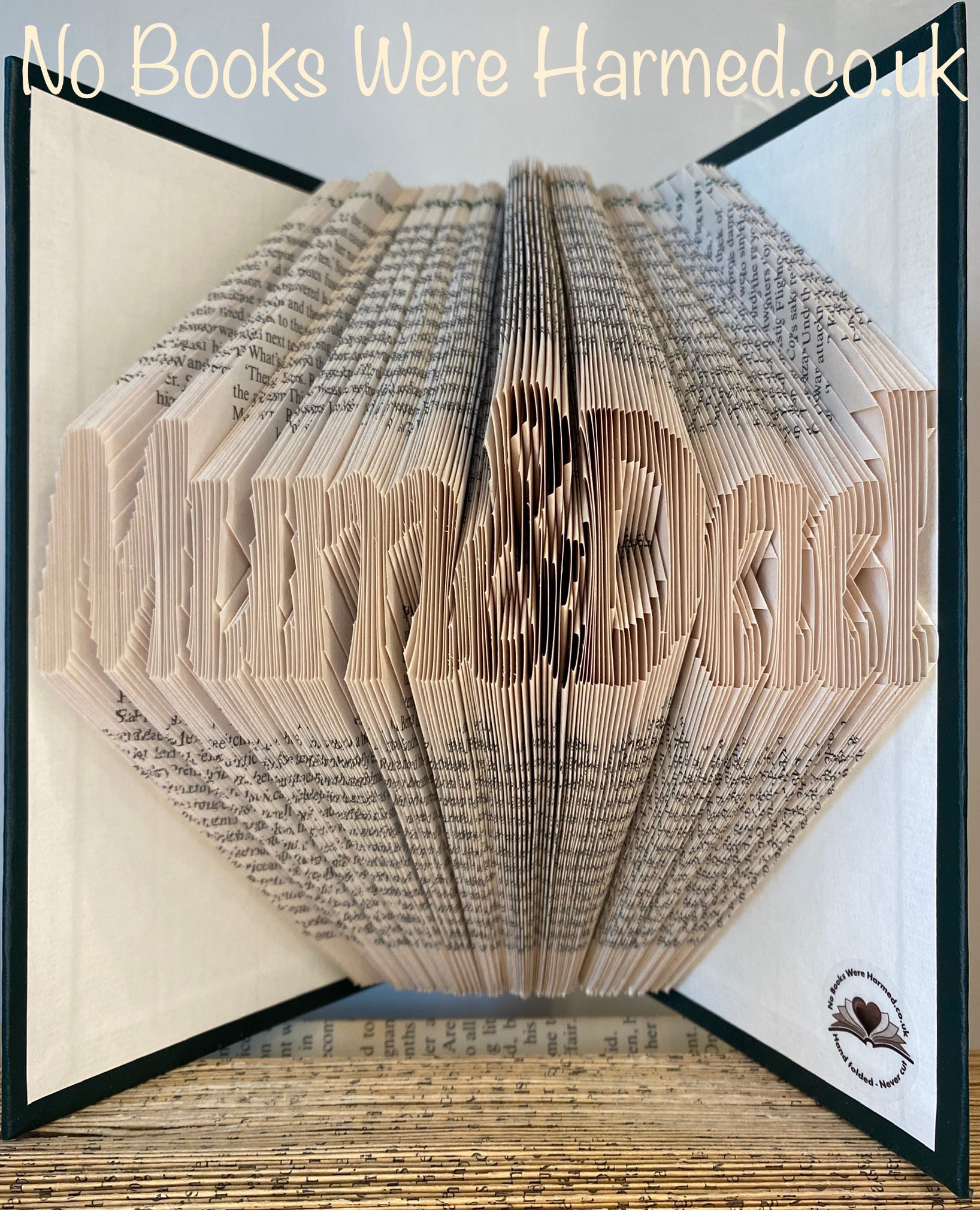 Handcrafted Mum&Dad book art featuring intricately folded pages from vintage books, showcasing unique designs and colors.