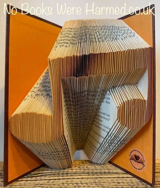 Handcrafted Music Note art made from vintage book pages, showcasing intricate folds and unique design.