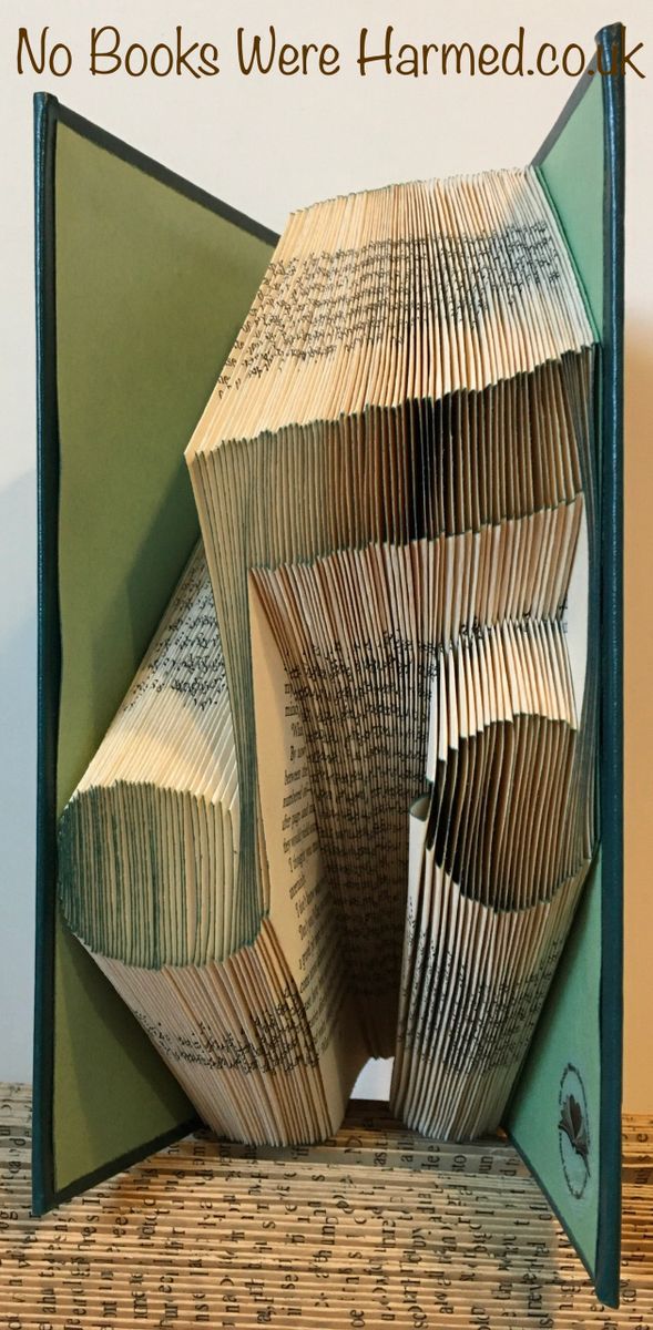 Handcrafted Music Note art made from vintage book pages, showcasing intricate folds and unique design.