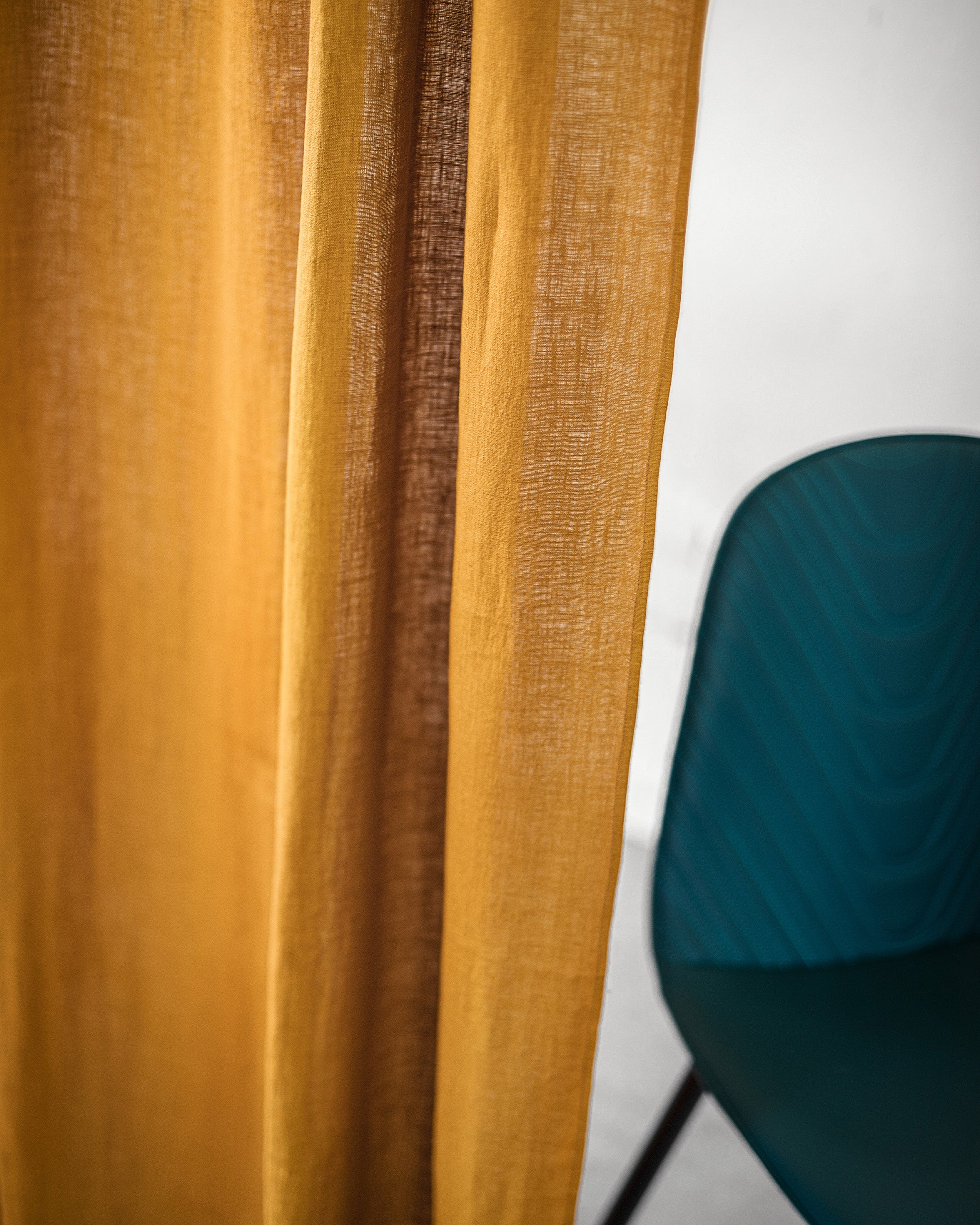 Mustard linen curtain with multifunctional heading tape, showcasing its semi-sheer fabric and elegant design.