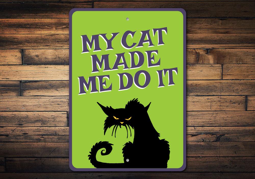 A humorous metal sign reading 'My Cat Made Me Do It', showcasing a playful design suitable for cat lovers.