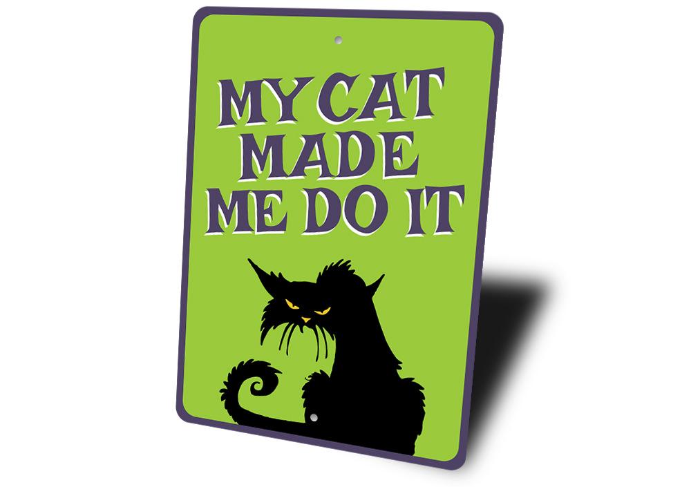 A humorous metal sign reading 'My Cat Made Me Do It', showcasing a playful design suitable for cat lovers.