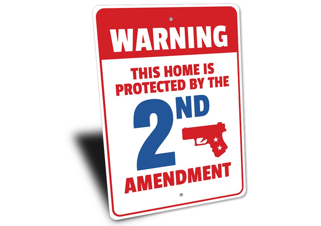 A decorative warning sign stating 'My Home is Protected by the 2nd Amendment', made of durable aluminum, featuring pre-drilled holes for easy mounting.