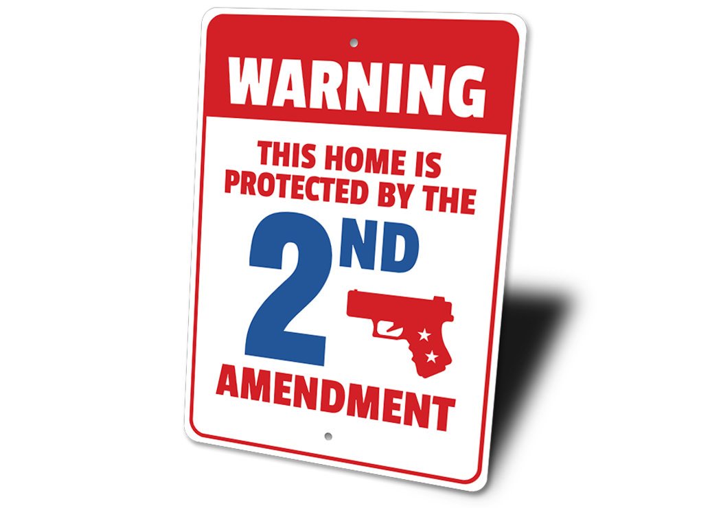 A decorative warning sign stating 'My Home is Protected by the 2nd Amendment', made of durable aluminum, featuring pre-drilled holes for easy mounting.