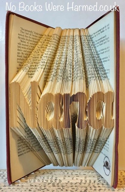 Hand-folded book art piece named 'Nana', crafted from vintage books, showcasing unique folds and textures.