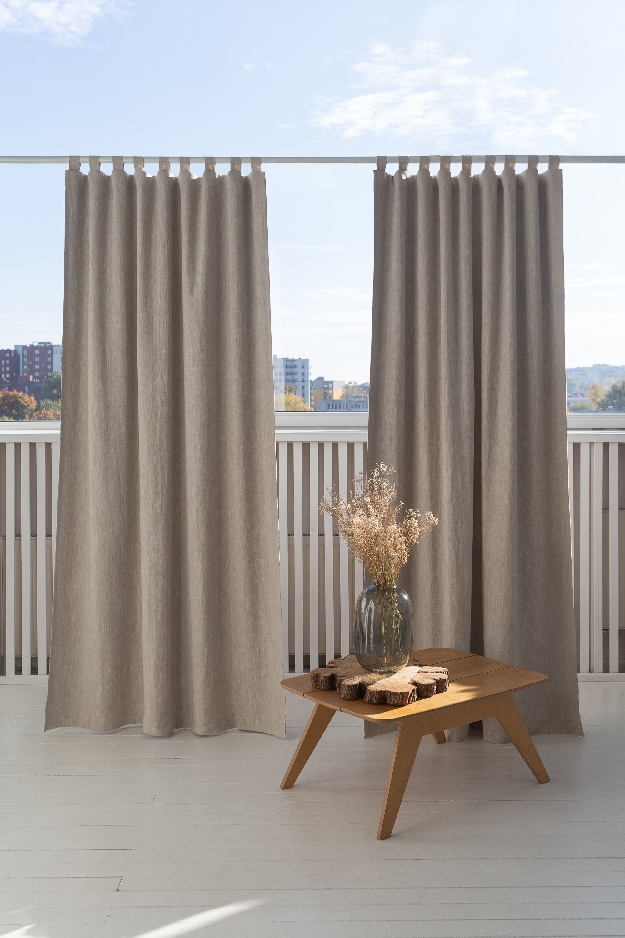 Natural linen curtain with blackout tabs, showcasing elegant design and solid color.