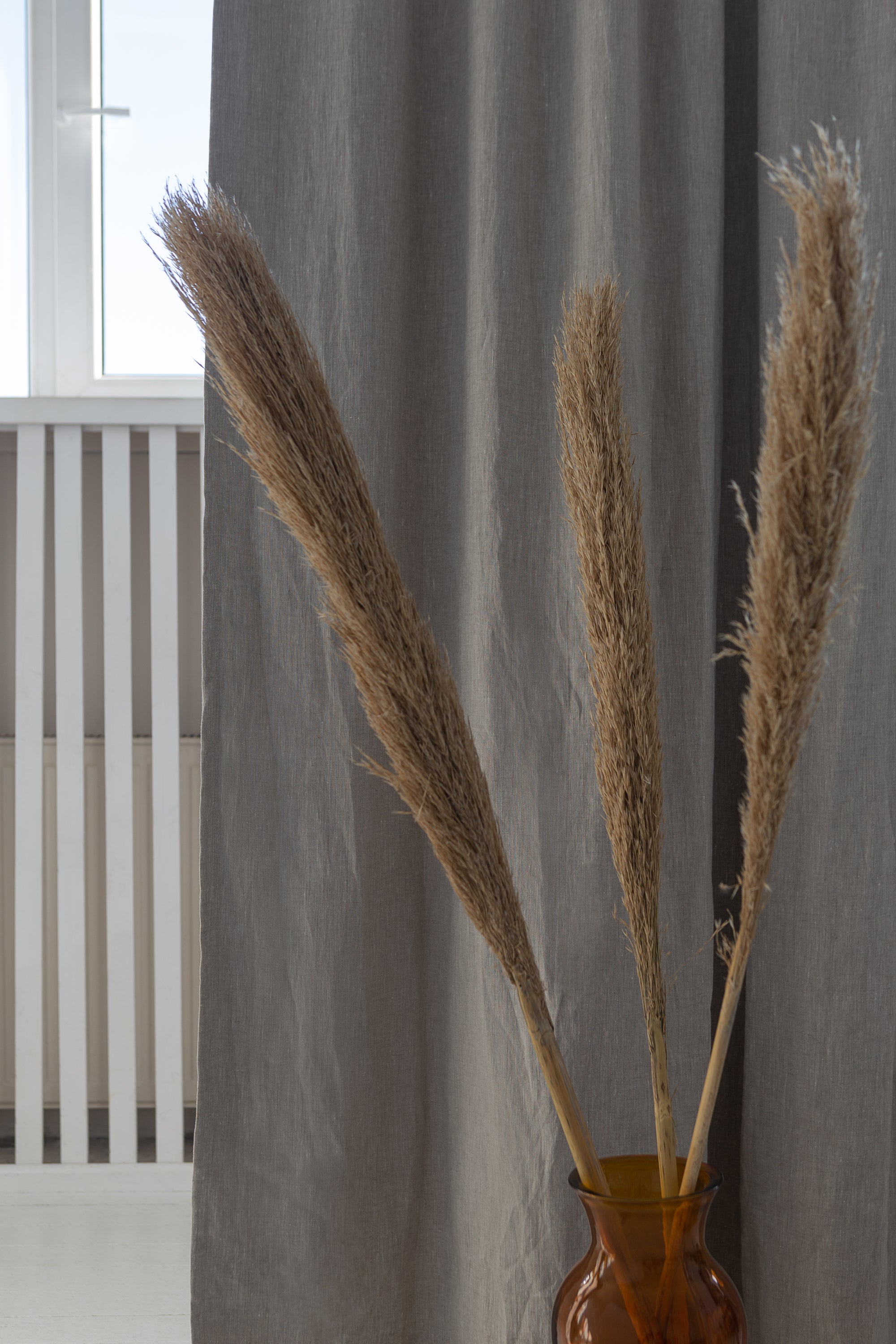 Natural linen curtain with blackout tabs, showcasing elegant design and solid color.