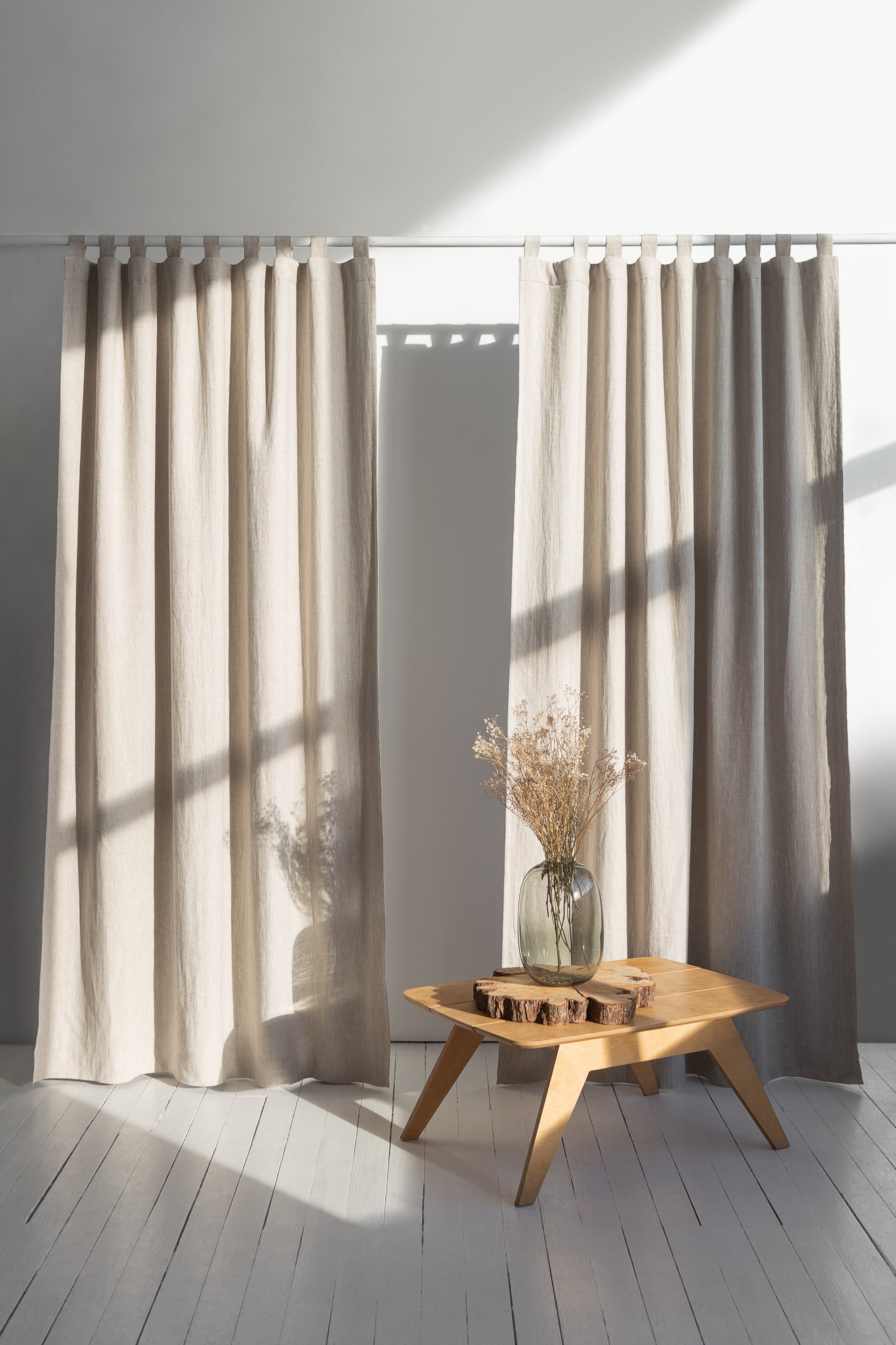 Natural linen curtain with blackout tabs, showcasing elegant design and solid color.