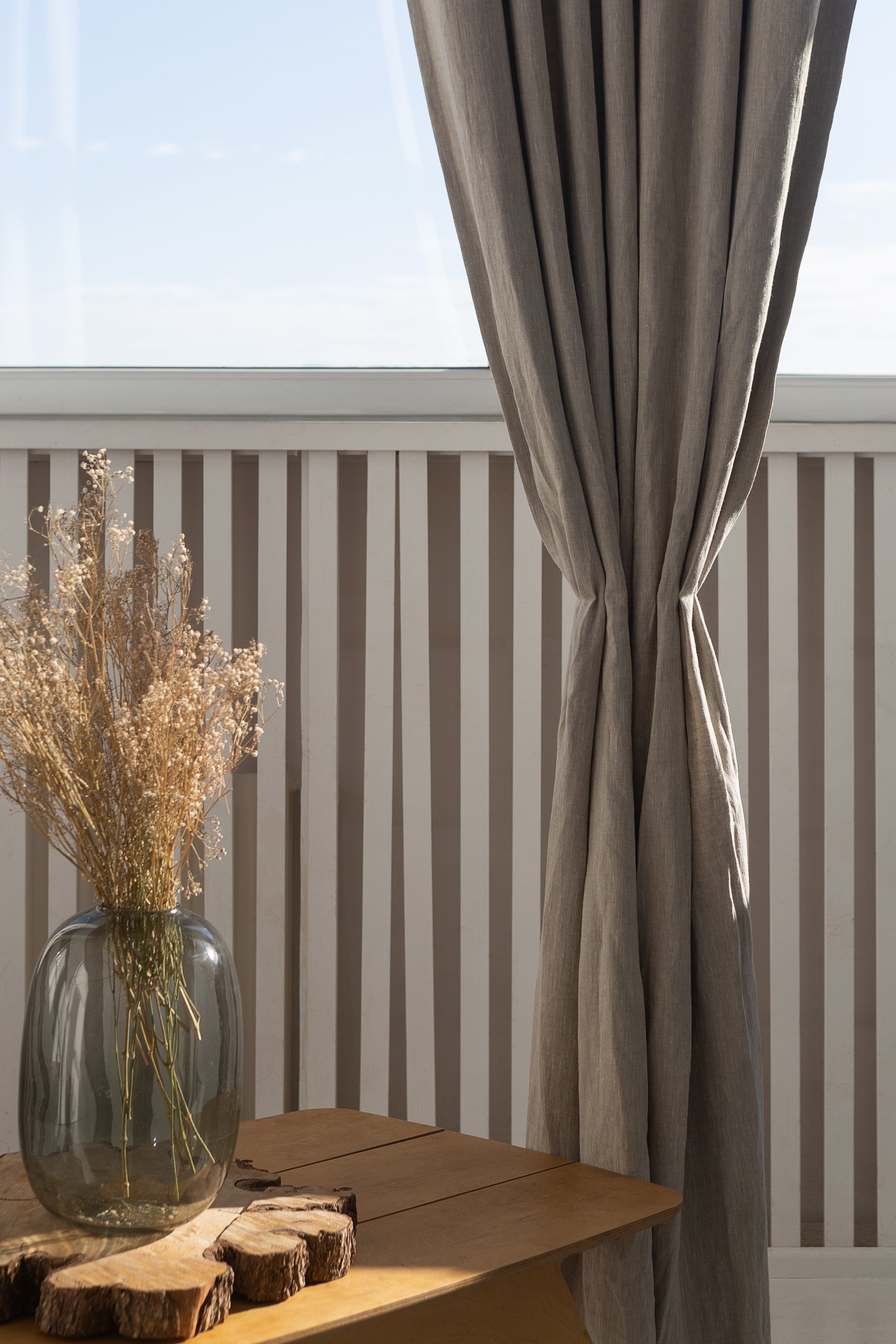 Natural linen curtain with blackout tabs, showcasing elegant design and solid color.