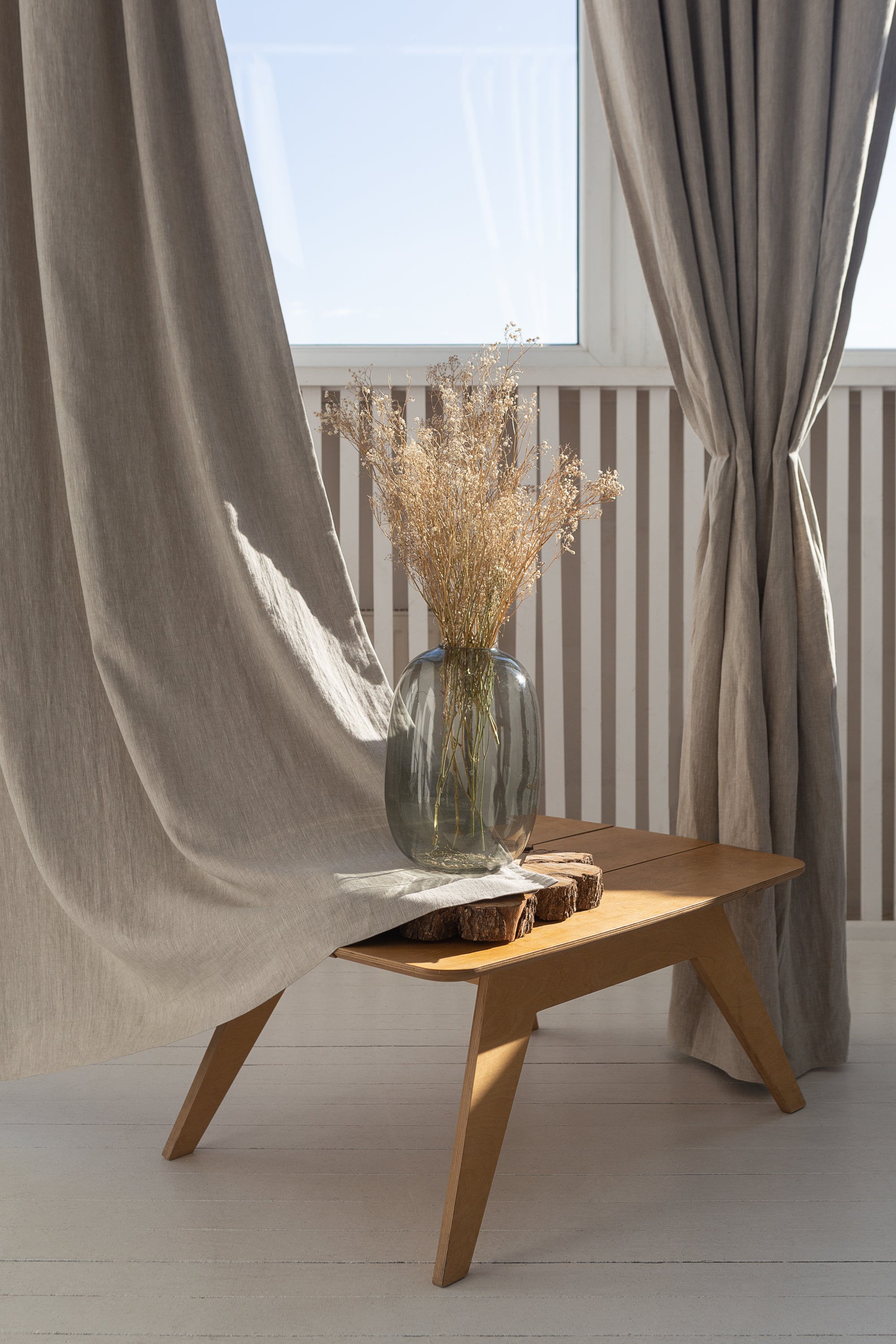 Natural linen curtain with blackout tabs, showcasing elegant design and solid color.