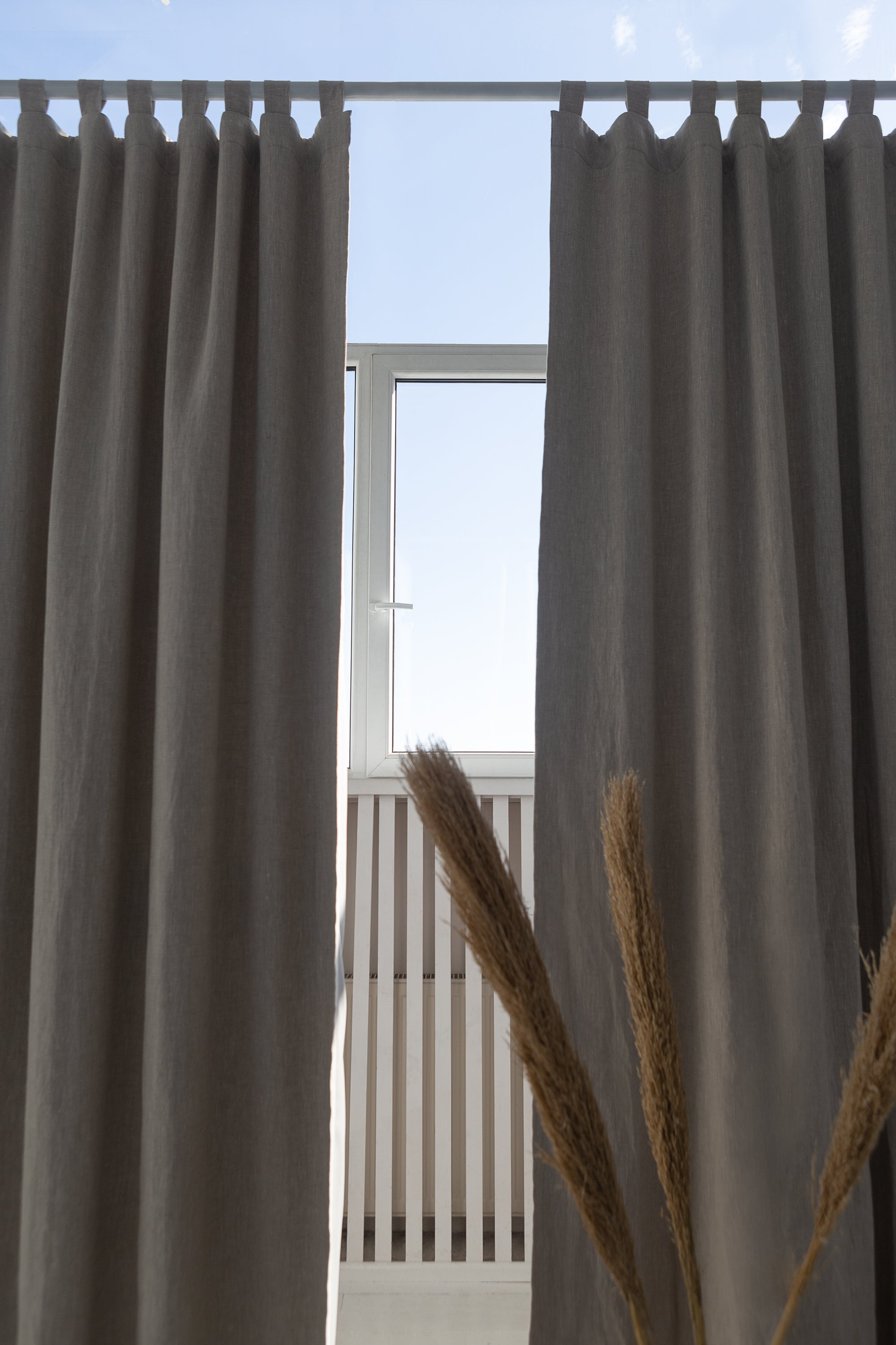 Natural linen curtain with blackout tabs, showcasing elegant design and solid color.