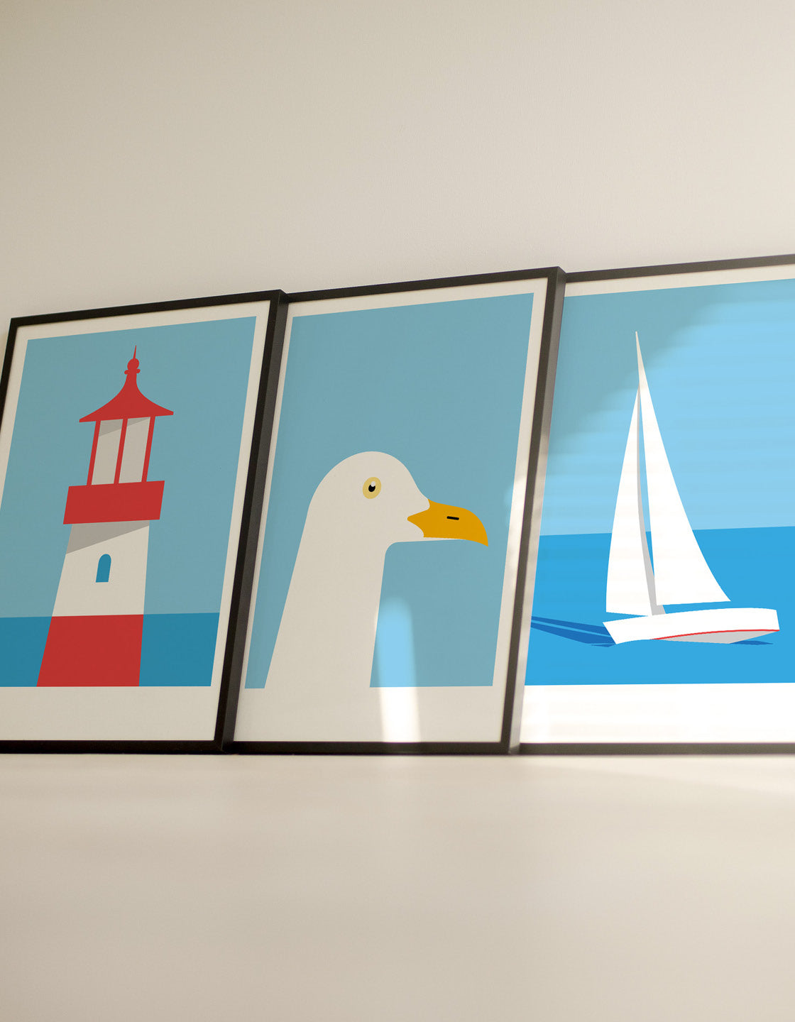 A set of three modern art prints featuring nautical themes, perfect for coastal decor.