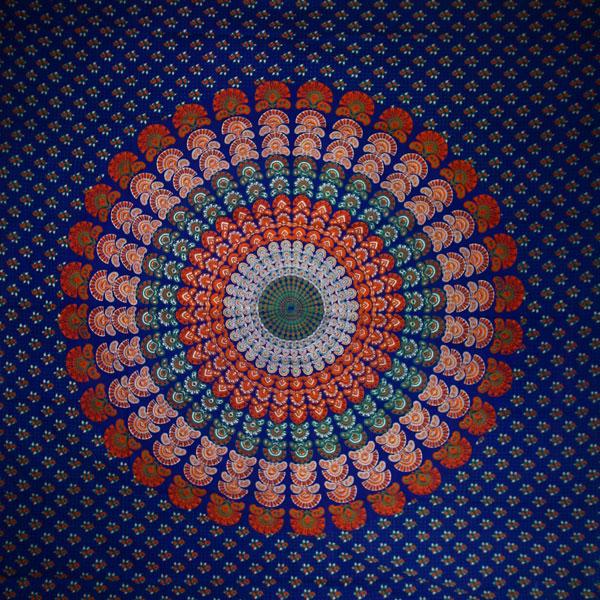 Navy Blue Peacock Dance Mandala Tapestry showcasing vibrant peacock feather designs on a rich blue background.