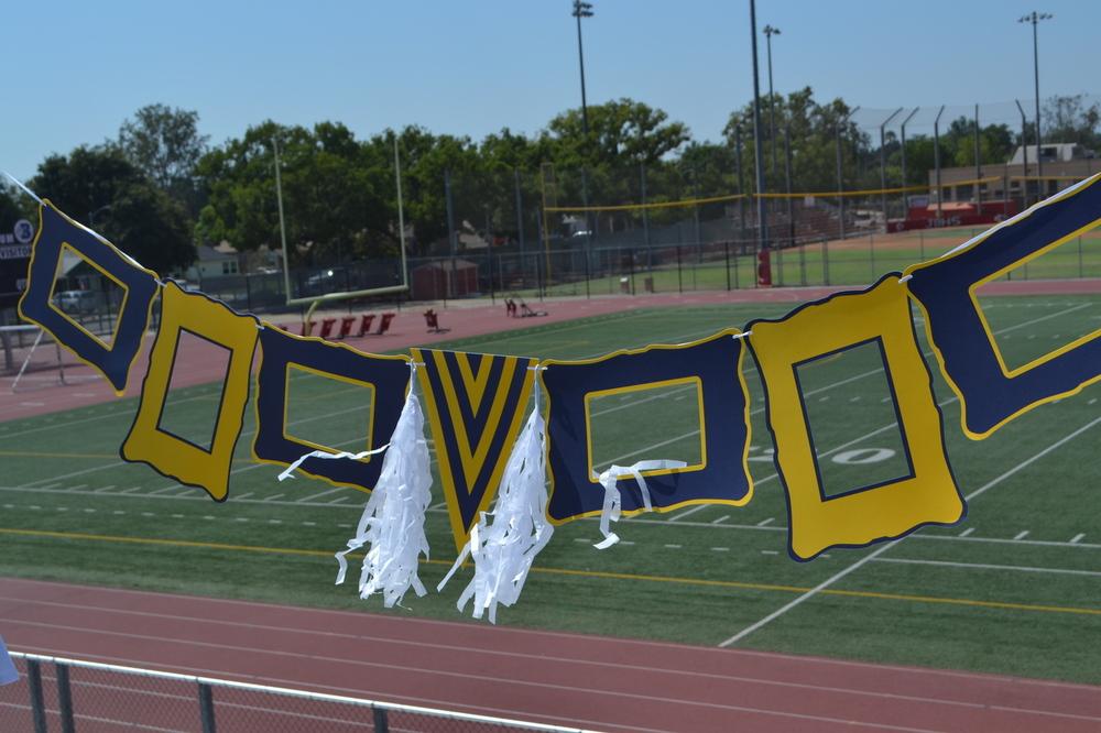 Navy and gold party decoration set featuring paper frames, tassels, and ribbon for elegant celebrations.