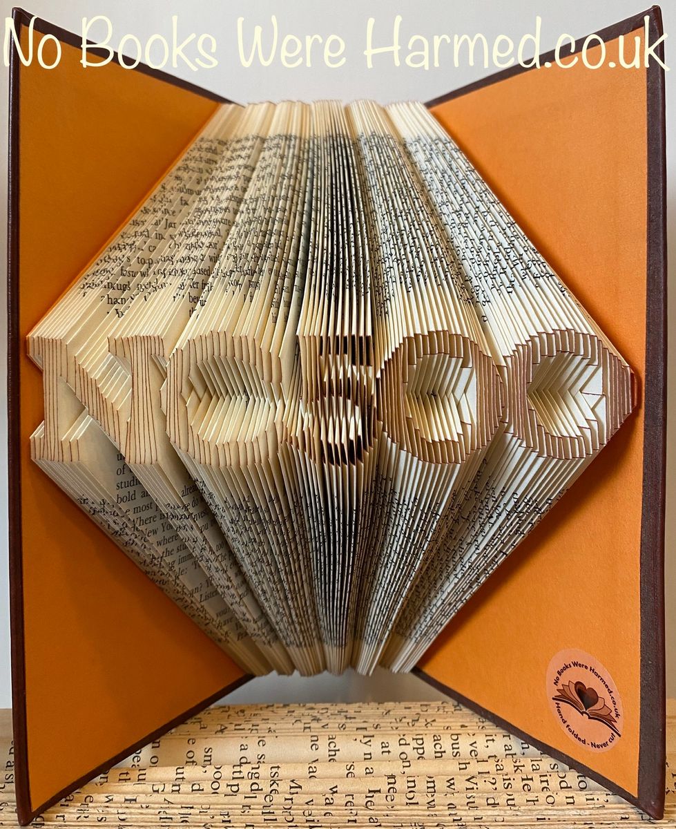 Handcrafted NC500 North Coast 500 souvenir made from vintage book pages, showcasing unique folded designs.