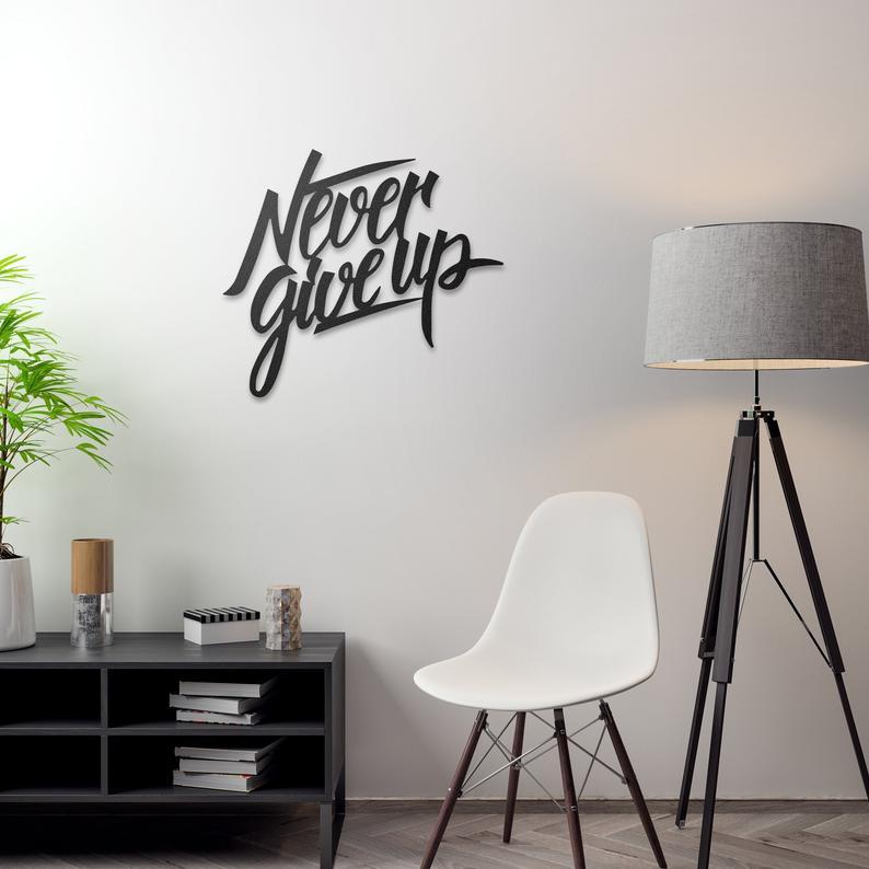 Never Give Up Metal Wall Art featuring a motivational design crafted from high-quality steel with a low gloss finish.