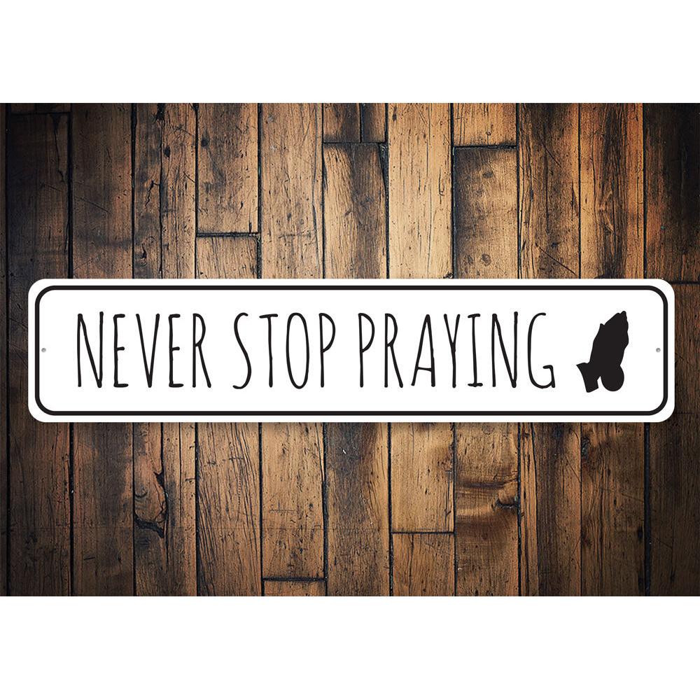 Never Stop Praying Sign made of durable aluminum, featuring inspirational text, perfect for home decor.