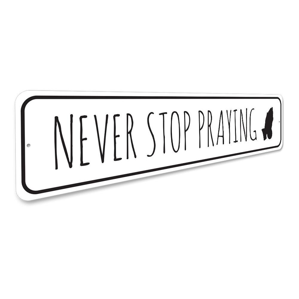 Never Stop Praying Sign made of durable aluminum, featuring inspirational text, perfect for home decor.