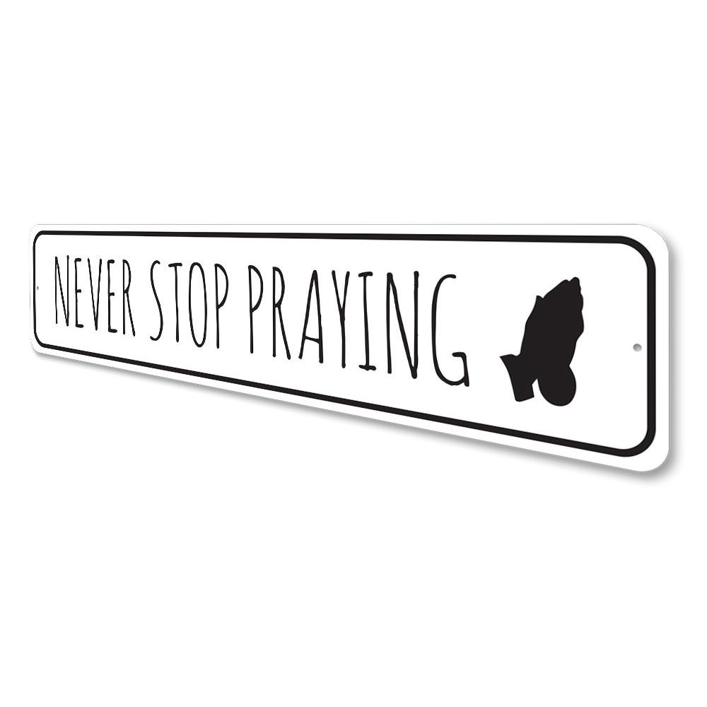 Never Stop Praying Sign made of durable aluminum, featuring inspirational text, perfect for home decor.