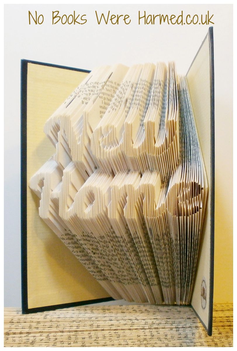 A unique piece of hand-folded book art made from vintage books, showcasing intricate designs and textures.